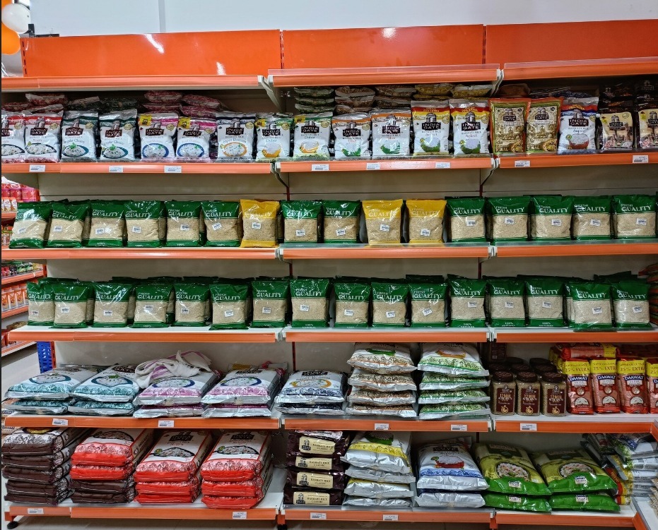 Large display of India Gate Basmati Rice packages and everyday grains stacked on shelves